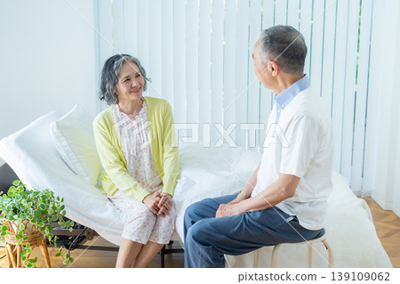 Senior couple sitting on a bed 139109062