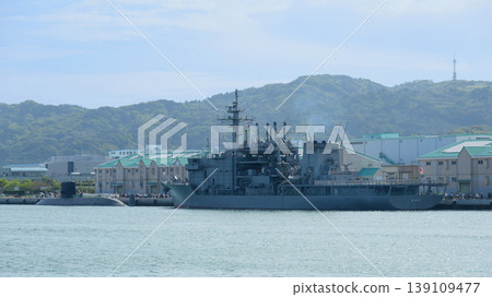 The Japan Maritime Self-Defense Force submarine rescue ship Chiyoda and the submarine Takashio are anchored at the harbor. 139109477