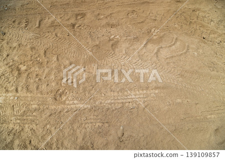 Tire tracks and hoof prints on fine dust covered ground Tire tracks and hoof prints on fine dust covered ground 139109857