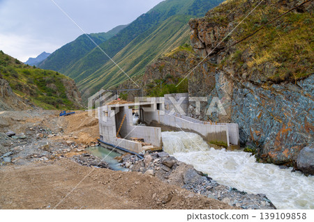 Partially Constructed Hydroelectric Dam in Mountain Valley Partially Constructed Hydroelectric Dam in Mountain Valley 139109858