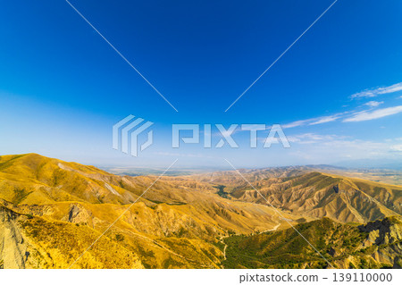 Expansive view of rolling hills in vast dry grass landscape 139110000