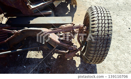 Close view of a vehicle suspension system and tire on a gravel surface Close view of a vehicle suspension system and tire on a gravel surface 139110706