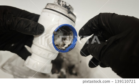 Cleaning a sink trap to remove dirt and clogs in a bathroom Cleaning a sink trap to remove dirt and clogs in a bathroom 139110721