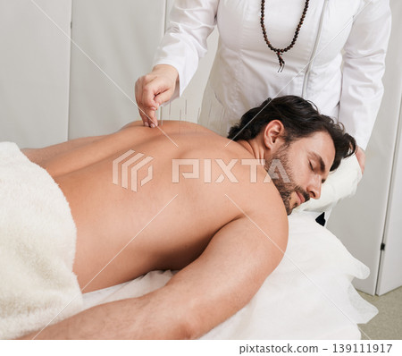 Treatment of back pain and tightness with acupuncture needles for a male patient, Traditional Chinese Medicine. Alternative medicine, reflexology Treatment of back pain and tightness with acupuncture needles for a male patient, Traditional Chinese Medicine. Alternative medicine, reflexology 139111917