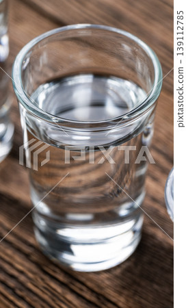 Vodka shot glass close up vertical Vodka shot glass close up vertical 139112785