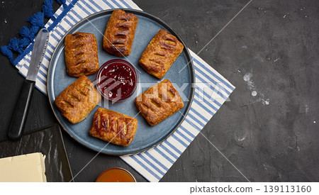 Freshly baked puff pastries on a blue plate with raspberry jam and butter Freshly baked puff pastries on a blue plate with raspberry jam and butter 139113160