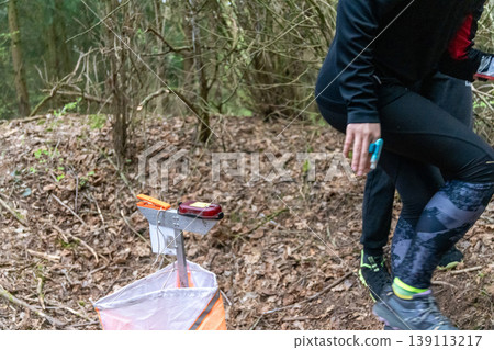 an orienteering control point with an orange flag an orienteering control point with an orange flag 139113217