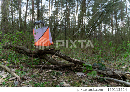 Orienteering control point with orange and white flag 139113224