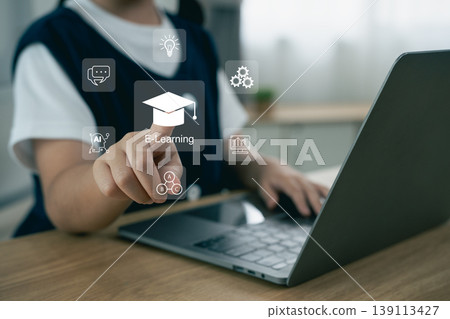 Student Engaging with E-Learning Technology and Digital Tools while Using Laptop in Modern Workspace 139113427
