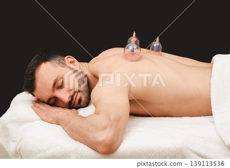 Treatment of pneumonia in man using vacuum cups. Vacuum cups enhance the patient's blood circulation. Say no pneumonia Treatment of pneumonia in man using vacuum cups. Vacuum cups enhance the patient's blood circulation. Say no pneumonia 139113536