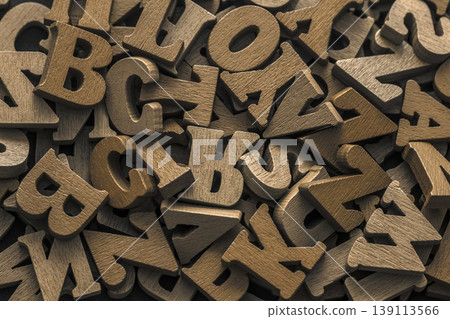 Pile of old vintage brown wooden letters. Typography background composition. Pile of old vintage brown wooden letters. Typography background composition. 139113566