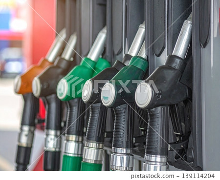 Fuel nozzles line up in a petrol station dispenser 139114204