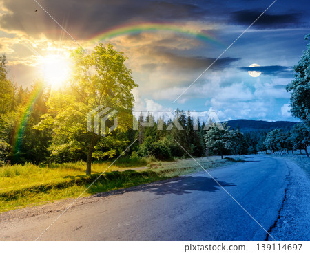 day meet night. view of a country road in mountains for travel. road journey through countryside summer scenery. sun and moon over forest on the background hill. epic sky. astrology and harmony 139114697