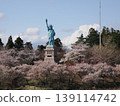 A Statue of Liberty surrounded by cherry trees in Oirase Town. 139114742