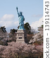 A Statue of Liberty standing among cherry trees in Oirase Town. 139114743
