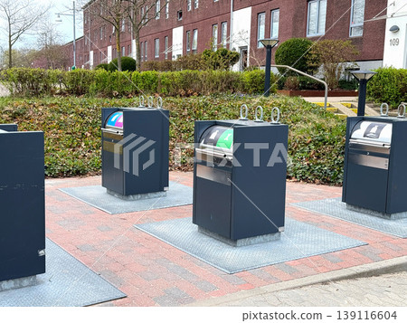 Underground waste containers for recycling in residential area. Underground waste containers for recycling in residential area. 139116604