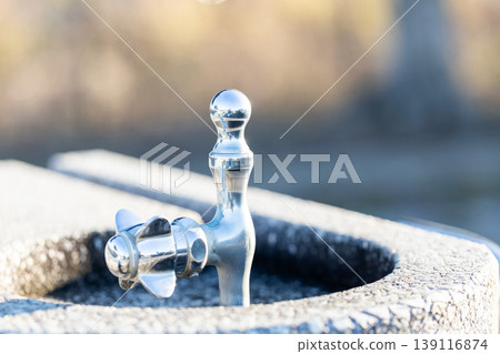 Upward-facing drinking faucet in the park Upward-facing drinking faucet in the park 139116874