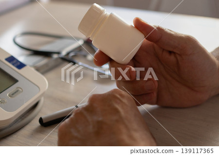 Hands of a doctor at his desk holding a medicine bottle. Health care. Hands of a doctor at his desk holding a medicine bottle. Health care. 139117365