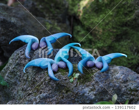 Fallen jade vine blossoms line the rocks, their jade-green hue shimmering. Fallen jade vine blossoms line the rocks, their jade-green hue shimmering. 139117602