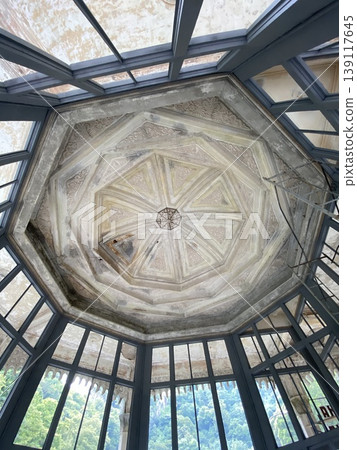 Ornate octagonal ceiling in historic building with geometric patterns and large windows Ornate octagonal ceiling in historic building with geometric patterns and large windows 139117645
