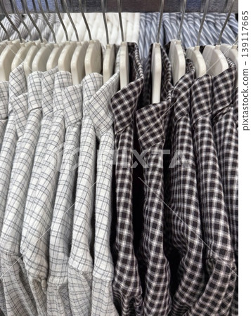Stacked checkered shirts in store display showcasing various plaid patterns, suitable for background Stacked checkered shirts in store display showcasing various plaid patterns, suitable for background 139117665