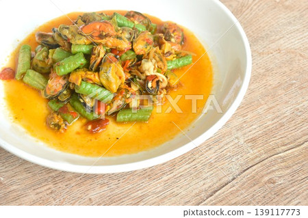 spicy stir fried slice yard long bean with mussel and basil leaf on plate  139117773