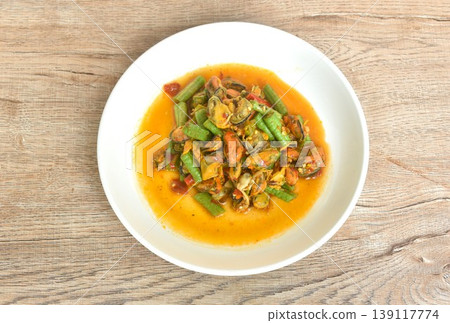 spicy stir fried slice yard long bean with mussel and basil leaf on plate  139117774