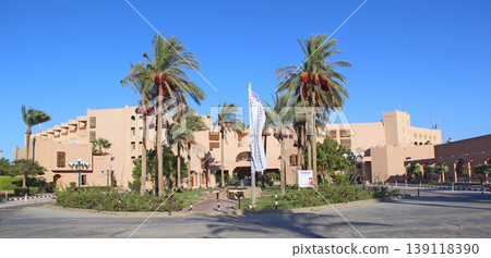 Palm trees and tropical vegetation growing in courtyard of resort Palm trees and tropical vegetation growing in courtyard of resort 139118390