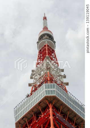 A low-angle, vertical image of the top of Tokyo Tower against a cloudy sky. A low-angle, vertical image of the top of Tokyo Tower against a cloudy sky. 139119045