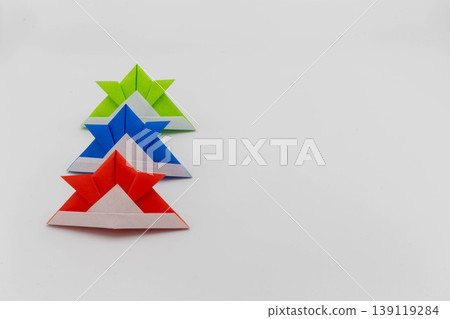 Origami samurai helmet, three colors arranged, copy space on the left, Children's Day (Tango no Sekku), material, white background 139119284