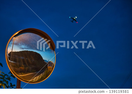 A curved mirror and an airplane A curved mirror and an airplane 139119381