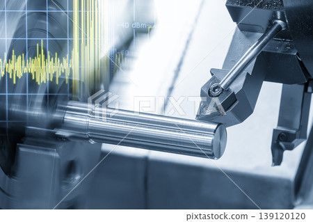 Double exposure of a CNC lathe machine cutting a metal shaft and a digital data graph monitor. Double exposure of a CNC lathe machine cutting a metal shaft and a digital data graph monitor. 139120120