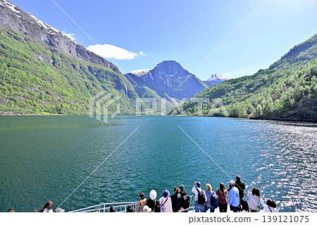 Passengers viewing the Nærøyfjord from a cruise ship. Passengers viewing the Nærøyfjord from a cruise ship. 139121075