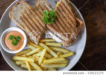 Grilled sandwiches with melted cheese on a wooden rustic board Grilled sandwiches with melted cheese on a wooden rustic board 139121173