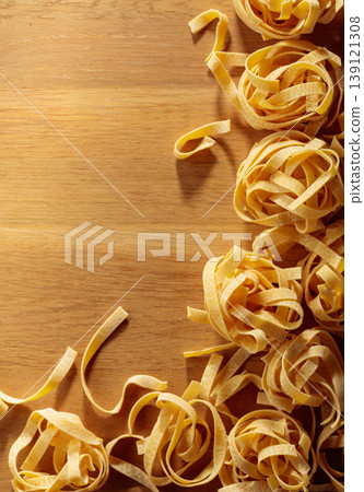 Raw dry noodles on a wooden table. Raw dry noodles on a wooden table. 139121308