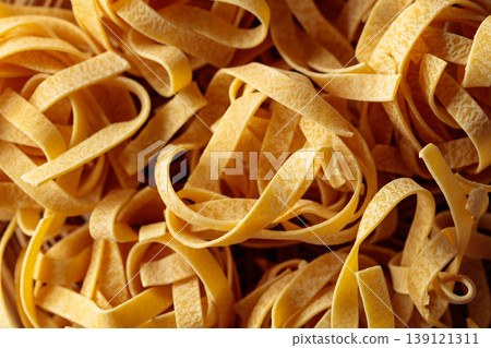 Raw dry noodles on a wooden table. Raw dry noodles on a wooden table. 139121311