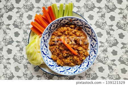 Northern Thai Meat and Tomato Spicy Dip (Nam Prik Ong) with Fresh Vegetables on Lace Northern Thai Meat and Tomato Spicy Dip (Nam Prik Ong) with Fresh Vegetables on Lace 139121329