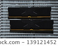 Black DDR5 RAM memory modules placed on a aluminum radiator. RAM shortages on the market, rising prices, and increased demand driven by the growing need for AI training. 139121452