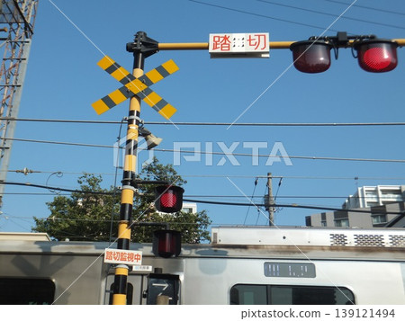 火車通過車站前的平交道。 火車通過車站前的平交道。 139121494
