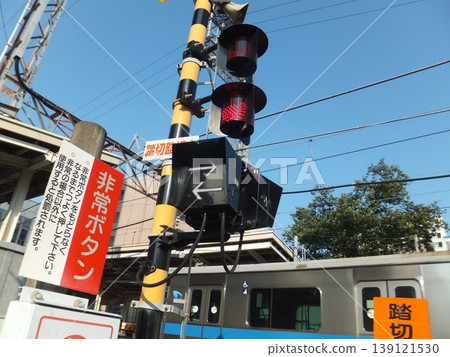 A level crossing where an Odakyu Line train is passing. A level crossing where an Odakyu Line train is passing. 139121530