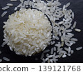 Raw rice in a black bowl Isolated on a blur background. 139121768