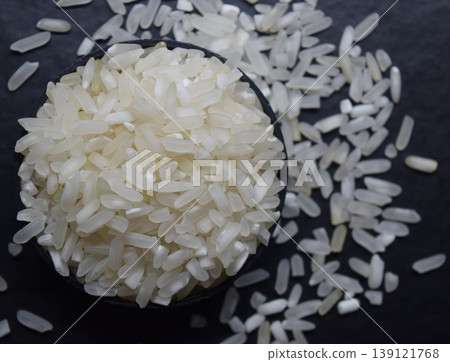 Raw rice in a black bowl Isolated on a blur background. Raw rice in a black bowl Isolated on a blur background. 139121768