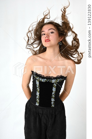 Portrait of a teenage girl with loose hair on a light background Portrait of a teenage girl with loose hair on a light background 139122830