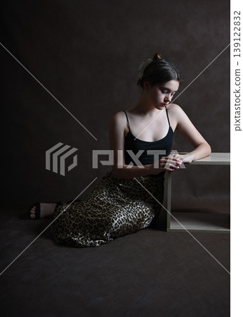 Teenage girl with dark hair poses in the studio Teenage girl with dark hair poses in the studio 139122832