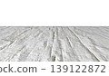 Perspective view of a flat wooden surface with a pronounced texture and annual rings. 139122872
