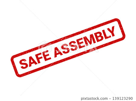 Textured red rubber stamp displaying the text safe assembly, signifying secure construction and careful manufacturing processes 139123290