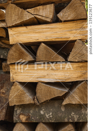 Neatly stacked dry firewood logs outdoors Neatly stacked dry firewood logs outdoors 139123677