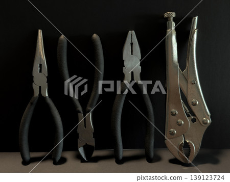 Hand Tools Flat Lay with Pliers and Locking Wrench on Dark Background DIY Repair Workshop Equipment Construction Maintenance Hardware Tool Set Close Up Hand Tools Flat Lay with Pliers and Locking Wrench on Dark Background DIY Repair Workshop Equipment Construction Maintenance Hardware Tool Set Close Up 139123724