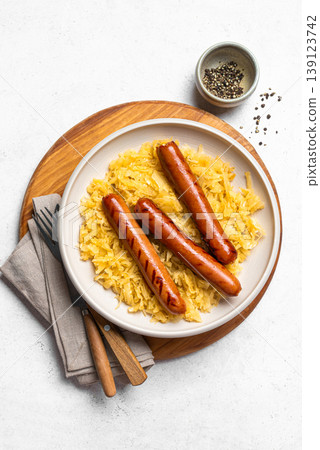 Stewed cabbage, sauerkraut and grilled sausages bratwurst Stewed cabbage, sauerkraut and grilled sausages bratwurst 139123742