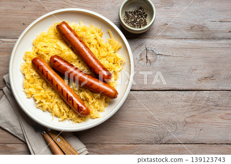 Stewed cabbage, sauerkraut and grilled sausages bratwurst Stewed cabbage, sauerkraut and grilled sausages bratwurst 139123743